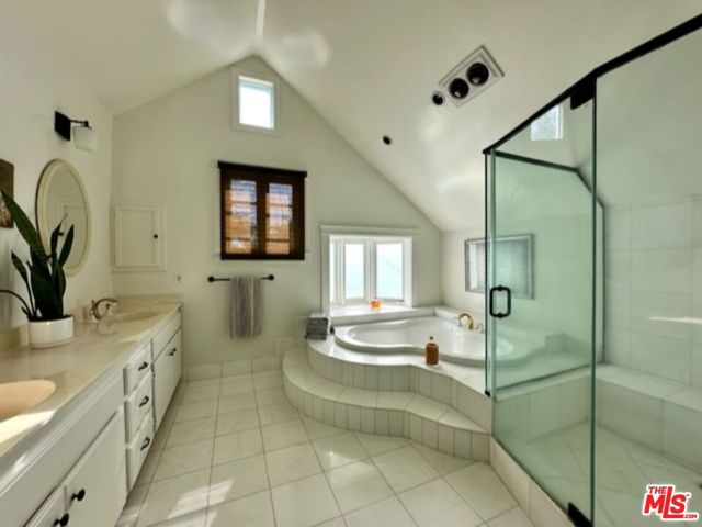 a bathroom with a tub sink and mirror