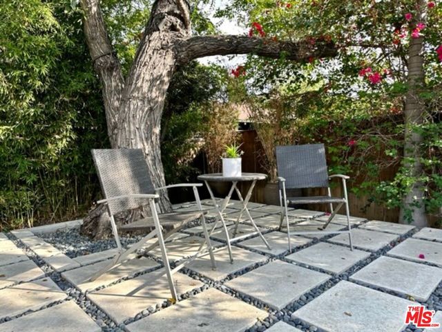 a view of a chairs and table in the patio