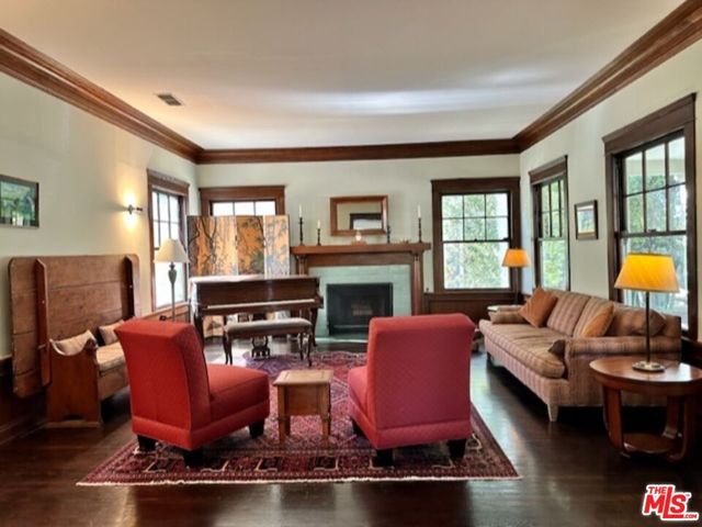 a living room with furniture fireplace and a large window