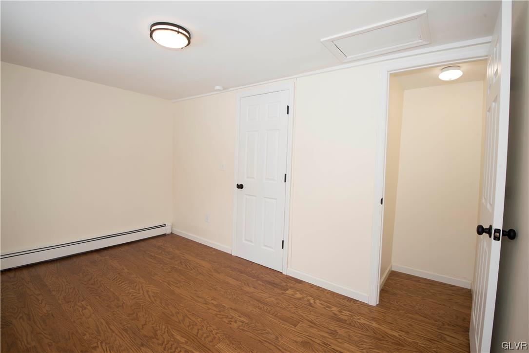 2244 Hillside Road Slatington, PA 18080 - Photo 18 of 32 an empty room with wooden floor and windows