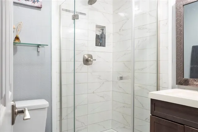 a bathroom with a shower toilet and sink