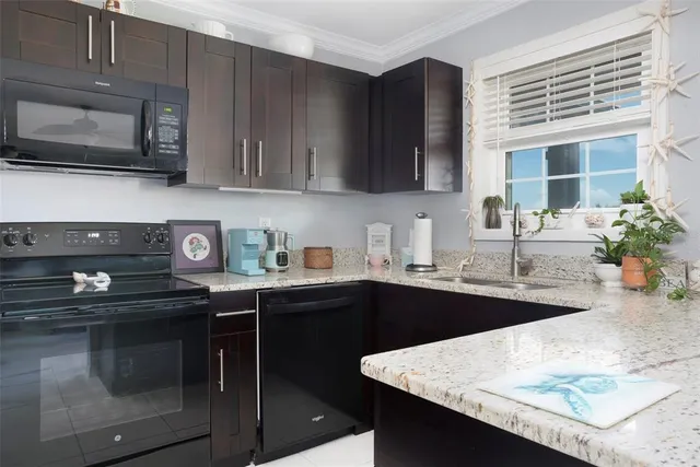 a kitchen with stainless steel appliances granite countertop a sink stove and microwave