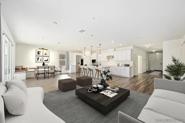 a living room with furniture and view of kitchen