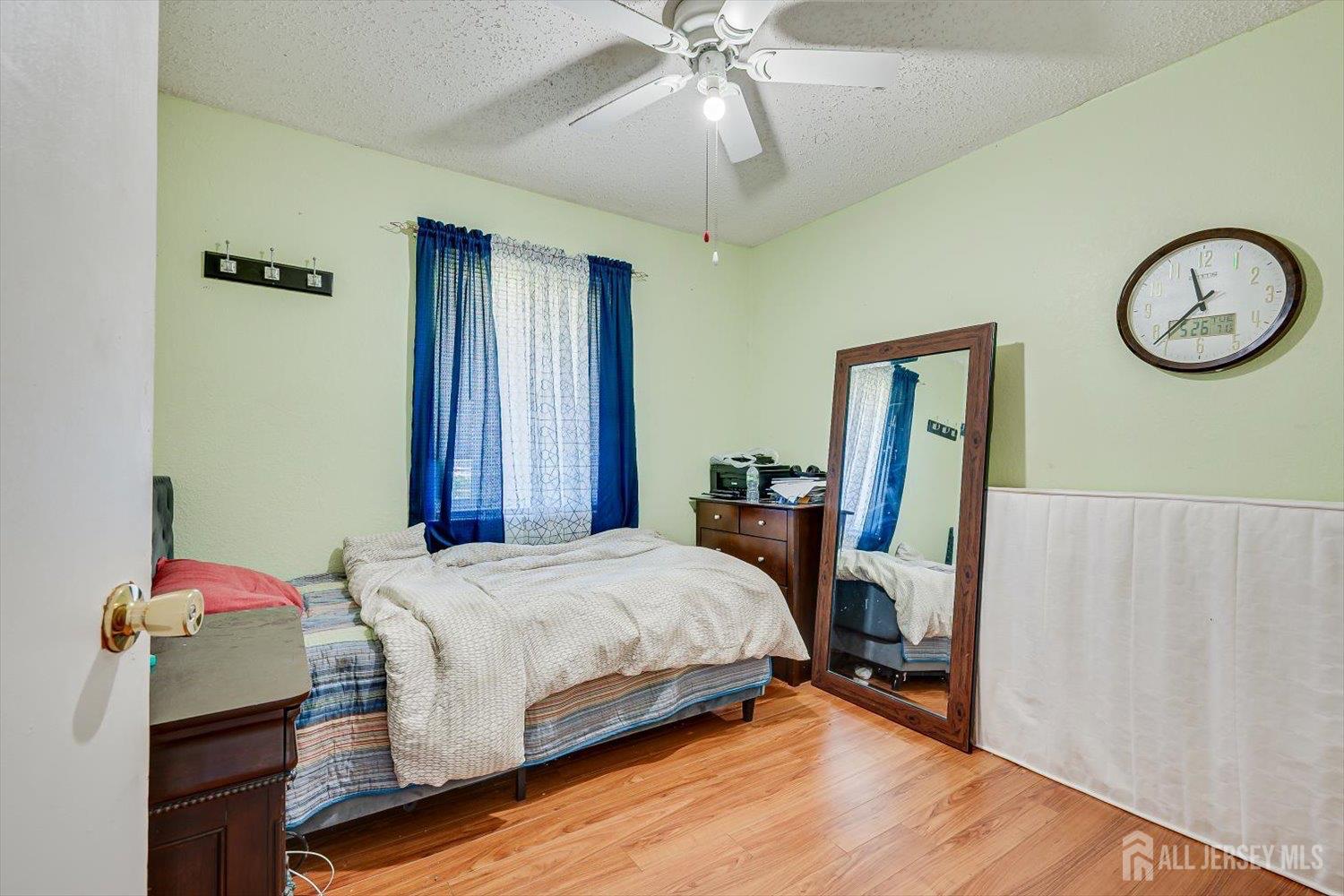 15 Markham Road Edison, NJ 08817 - Photo 27 of 32 a bedroom with a bed and a chandelier