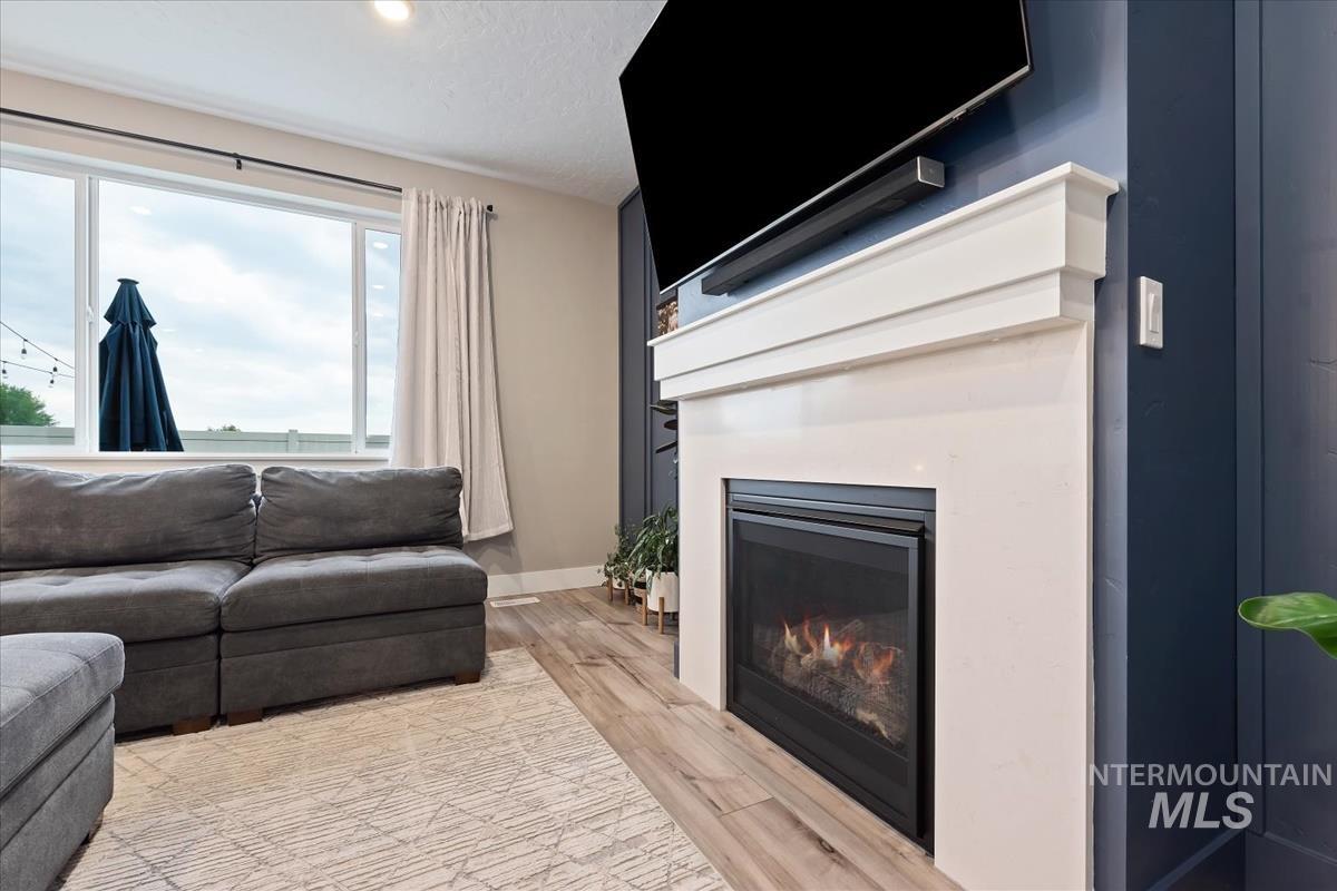 815 Knowledge Street Middleton, ID 83644 - Photo 9 of 49 White-mantled fireplace with a black insert