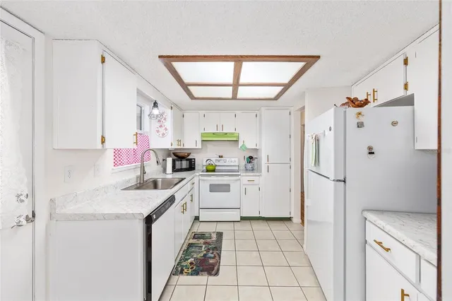 a kitchen with a sink stove and refrigerator