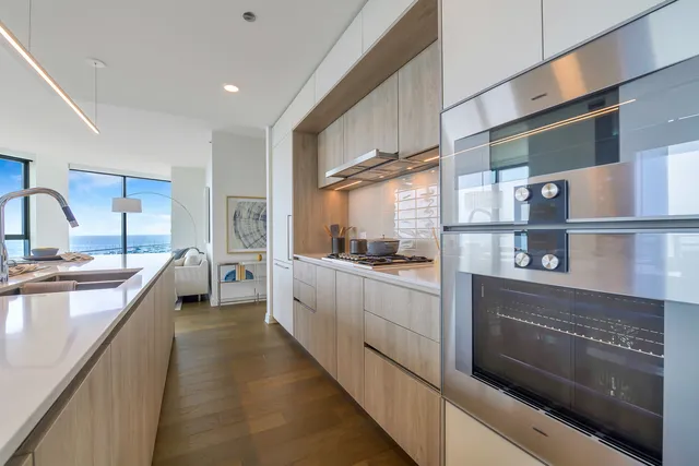 a kitchen with stainless steel appliances granite countertop a stove and a sink