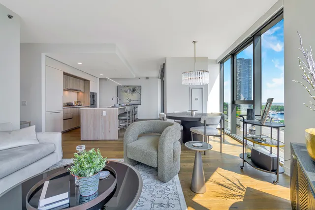 a living room with furniture and a chandelier
