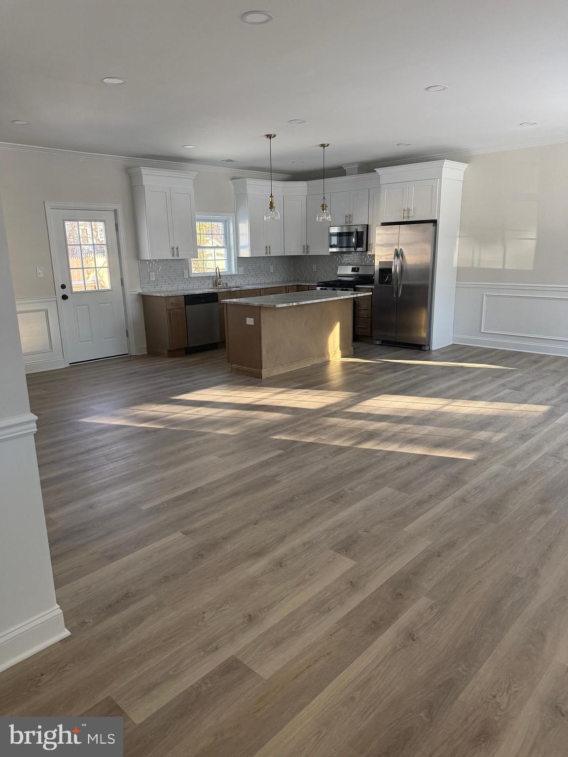 535 Princess Avenue Croydon, PA 19021 - Photo 4 of 14 a view of a kitchen with kitchen island a sink wooden floor and stainless steel appliances