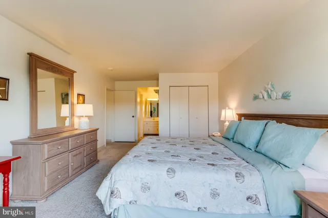 a bathroom with a granite countertop sink vanity and mirror