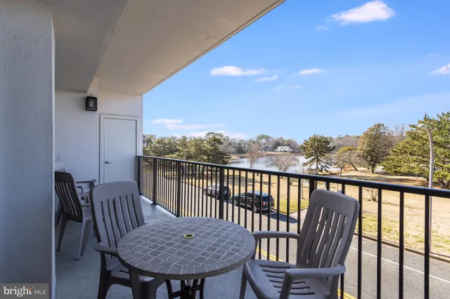 a view of a balcony with furniture and wooden floor