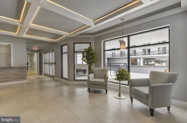 a living room with furniture and flowers