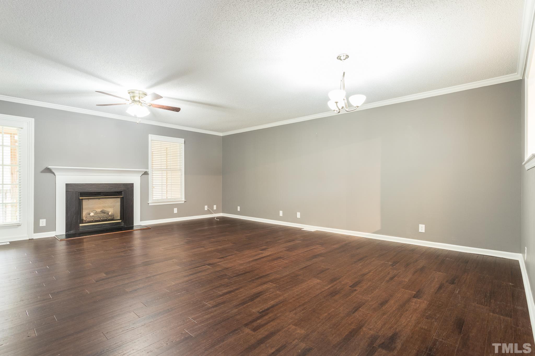 4428 Antique Lane Raleigh, NC 27616 - Photo 11 of 30 an empty room with wooden floor fan and windows