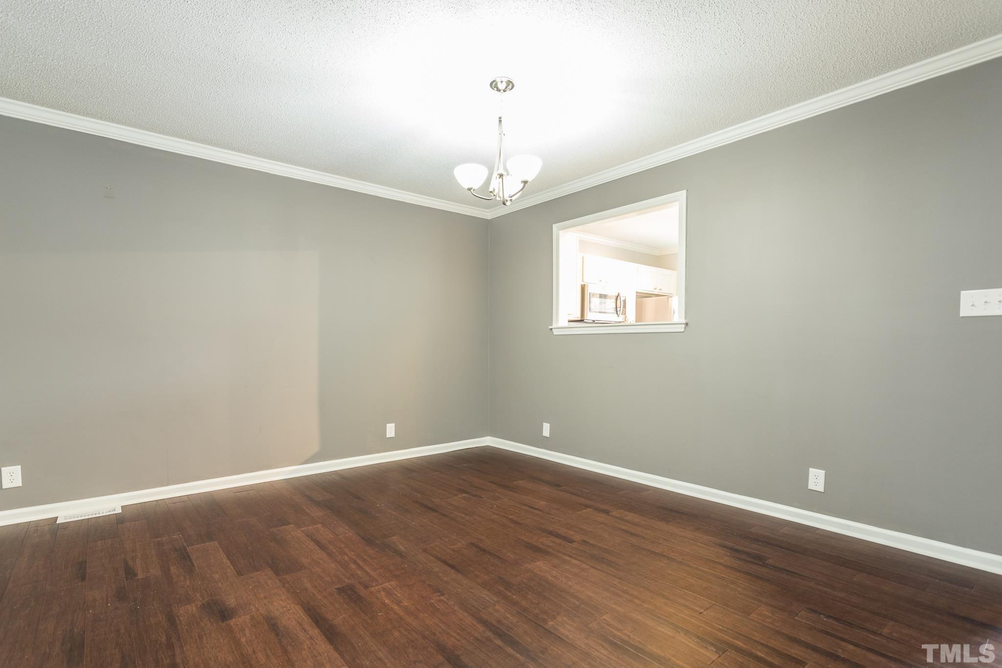 4428 Antique Lane Raleigh, NC 27616 - Photo 12 of 30 wooden floor in an empty room with a window