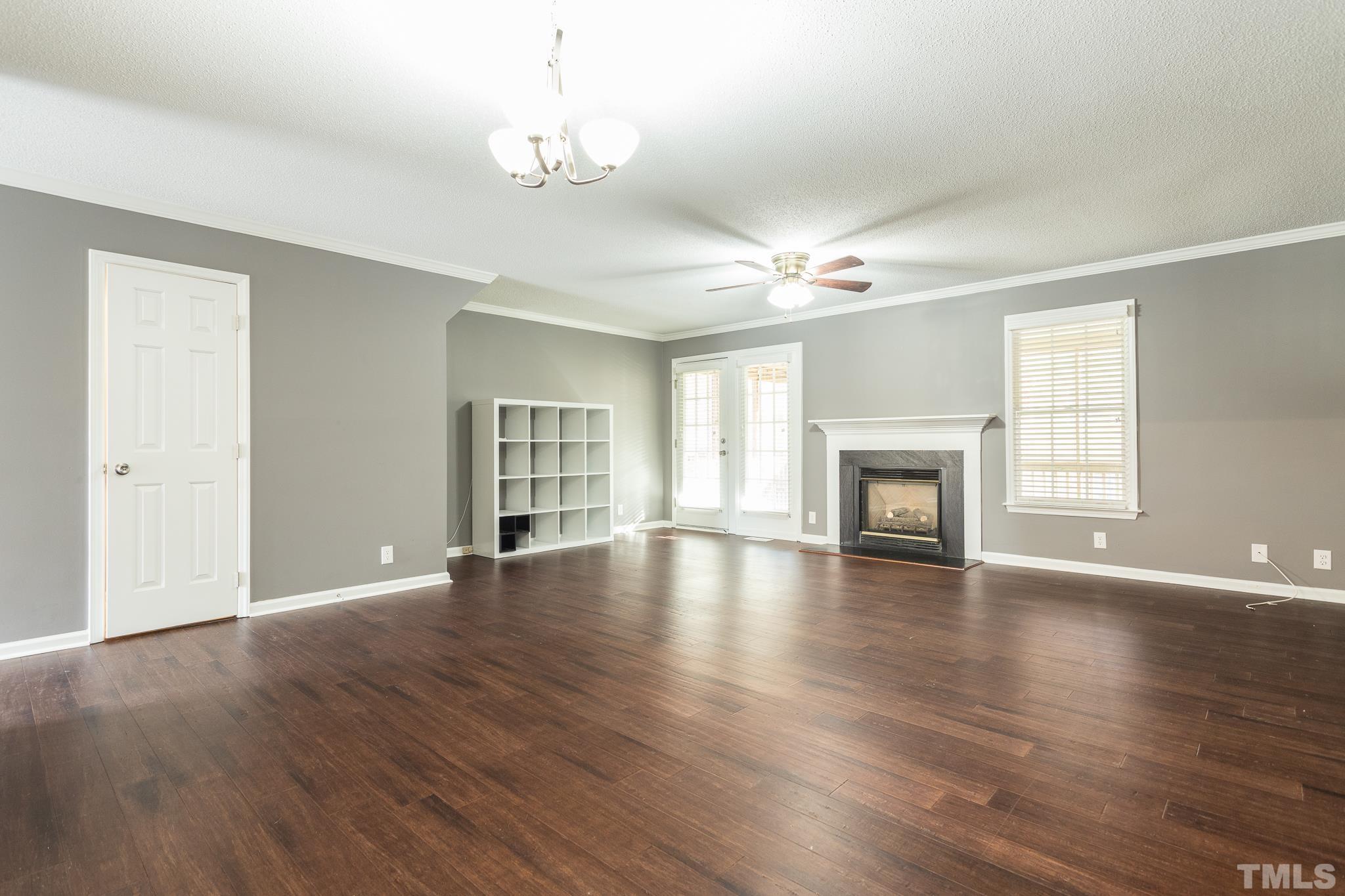 4428 Antique Lane Raleigh, NC 27616 - Photo 13 of 30 a view of an empty room with wooden floor and a window