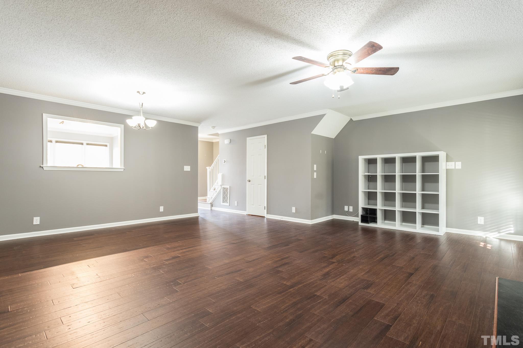 4428 Antique Lane Raleigh, NC 27616 - Photo 14 of 30 a view of an empty room with wooden floor and a window
