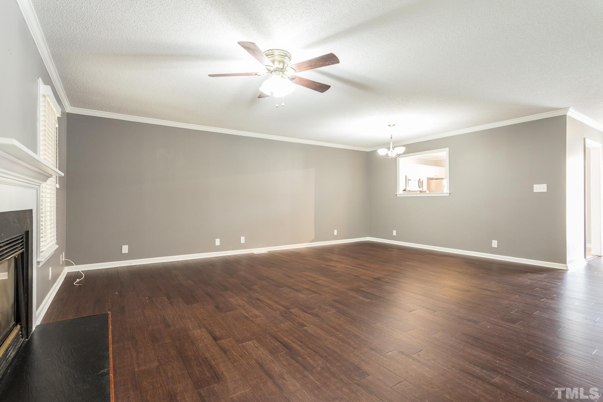 4428 Antique Lane Raleigh, NC 27616 - Photo 15 of 30 an empty room with wooden floor fan and windows
