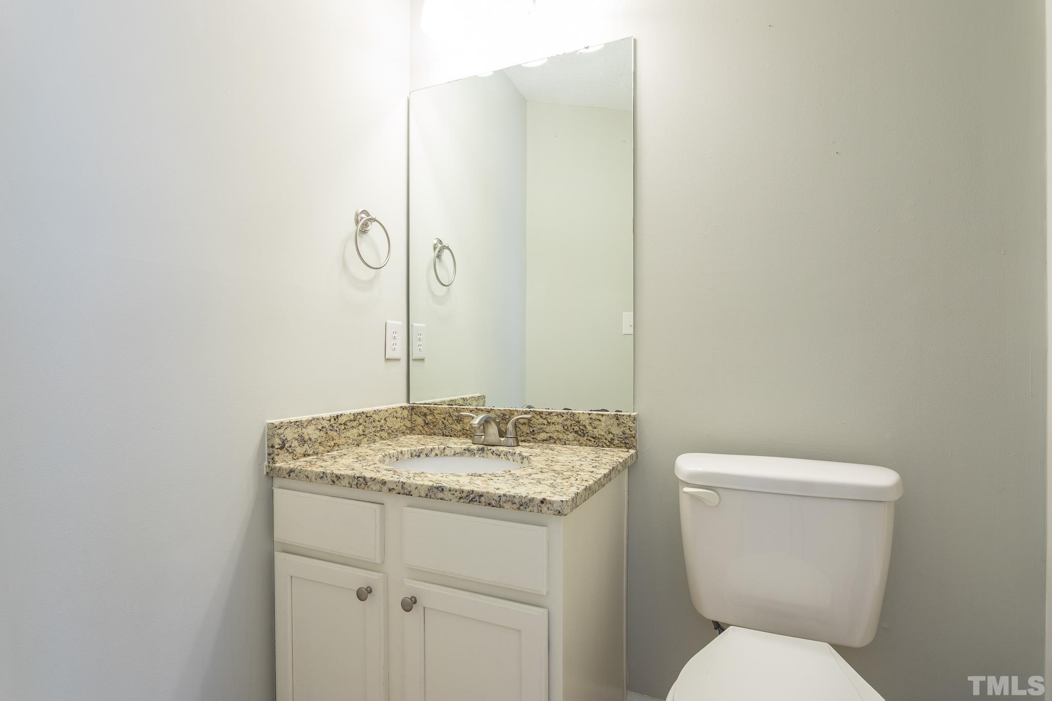 4428 Antique Lane Raleigh, NC 27616 - Photo 20 of 30 a bathroom with a granite countertop toilet and a sink