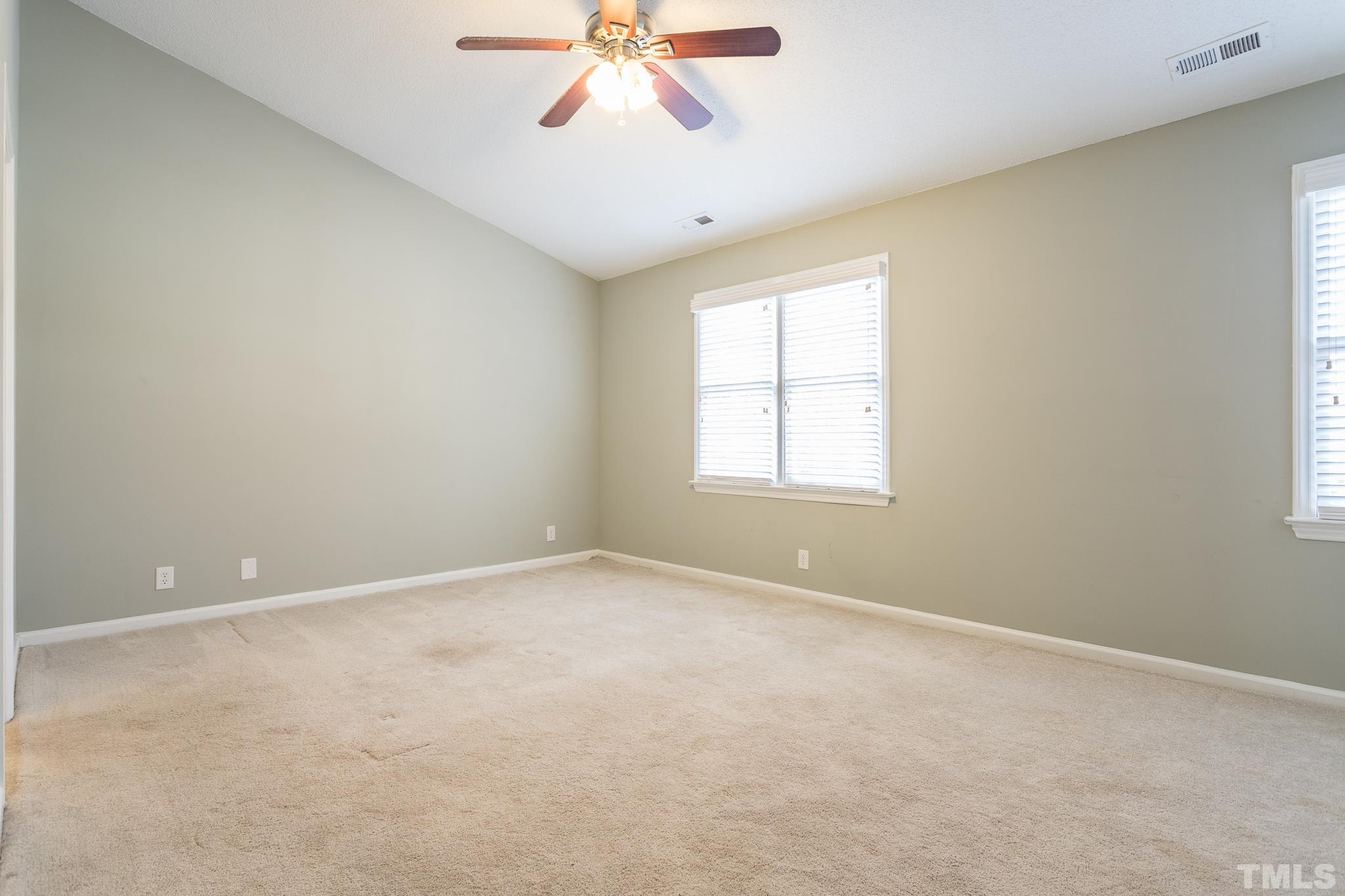 4428 Antique Lane Raleigh, NC 27616 - Photo 21 of 30 an empty room with a window and a fan