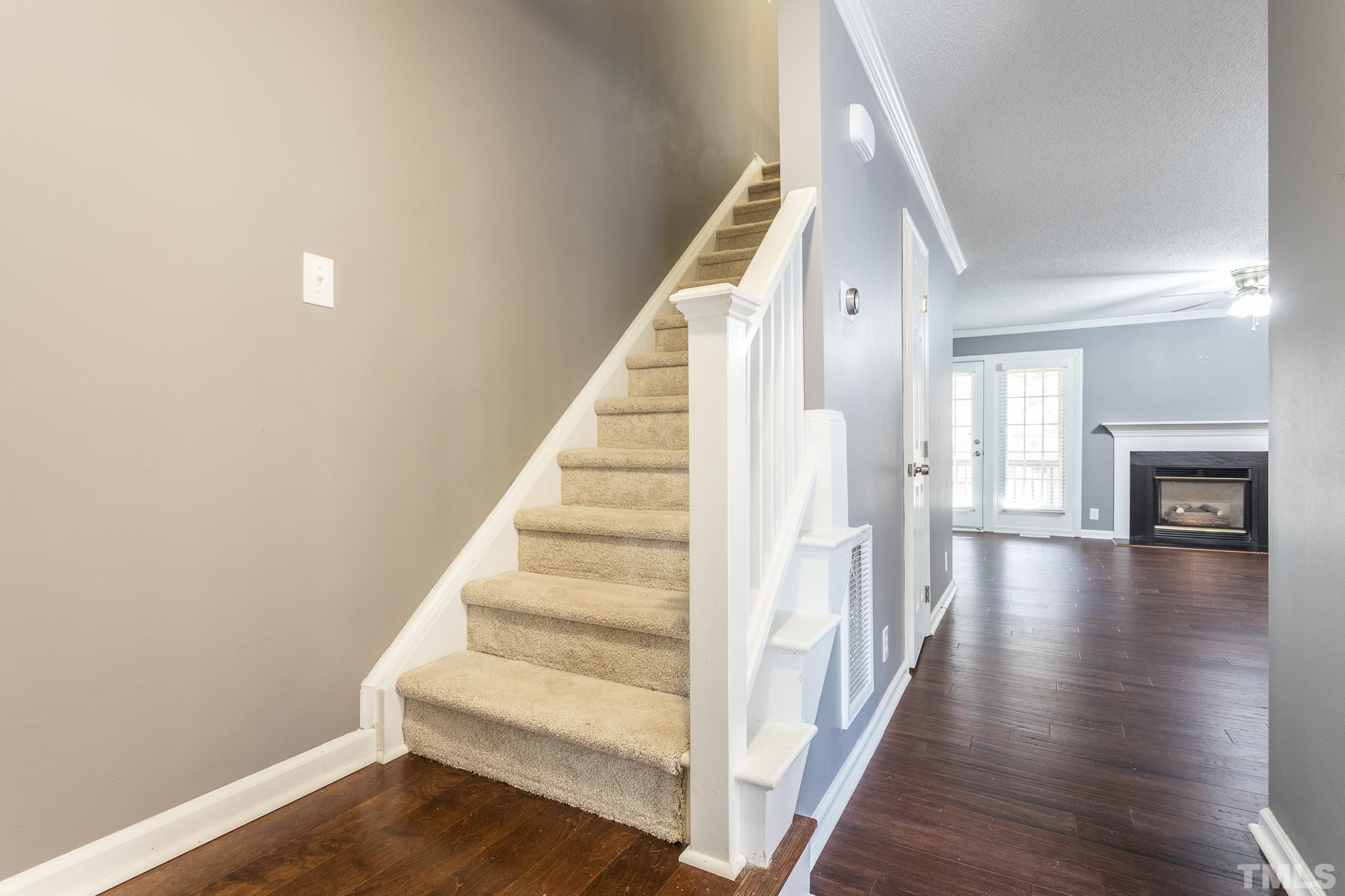 4428 Antique Lane Raleigh, NC 27616 - Photo 6 of 30 a view of a hallway with wooden floor and staircase