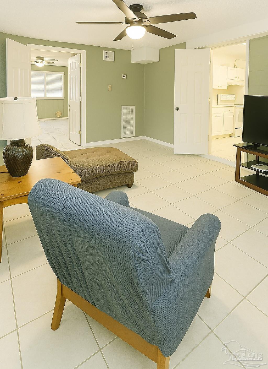6274 Munson Highway Milton, FL 32570 - Photo 7 of 26 a living room with a couch and a flat screen tv