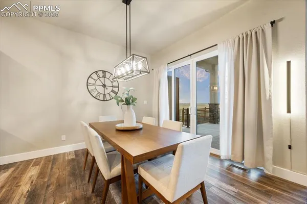 a view of a dining room with furniture window and wooden floor