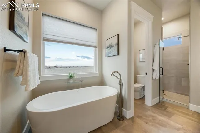 a white bath tub sitting next to a bathroom