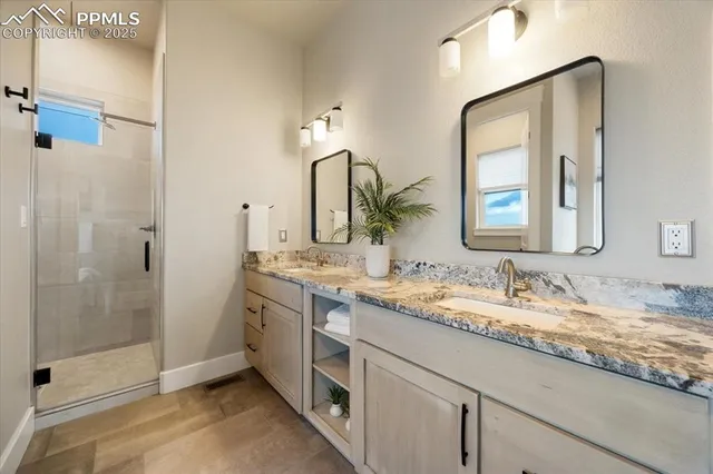 a bathroom with a granite countertop sink mirror and double