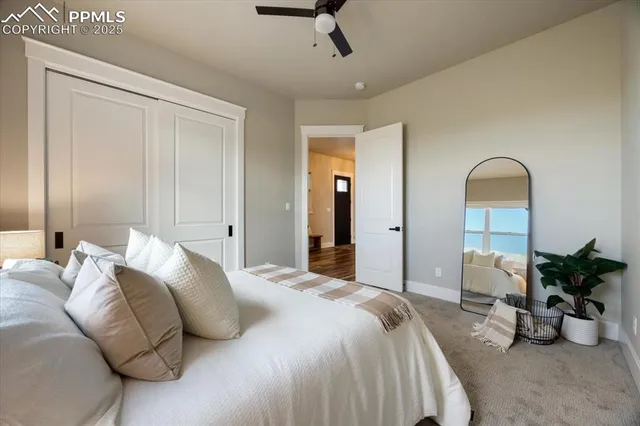 a bedroom with bed and a potted plant