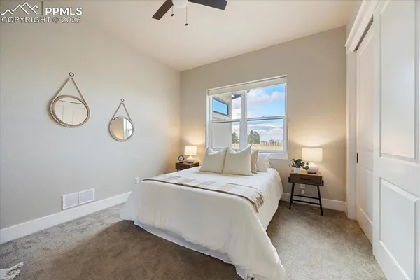 a bedroom with a bed and chandelier