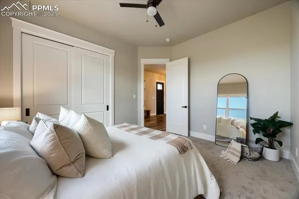 a bedroom with bed and a potted plant