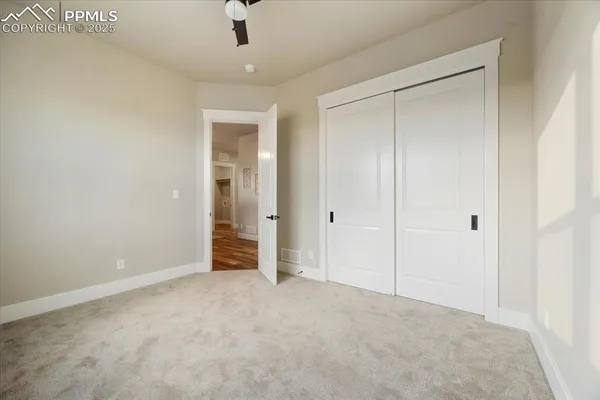 a view of an empty room and closet area