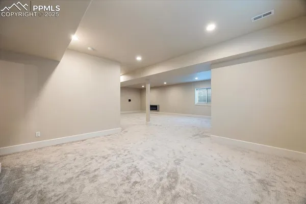 an empty room with an entryway and fan