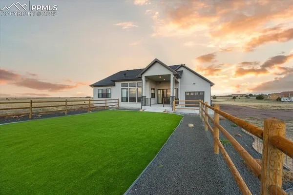 a view of an house with backyard space and garden