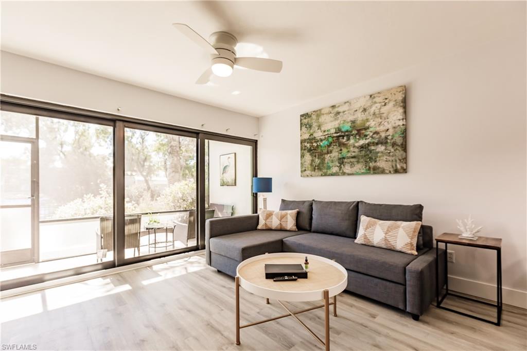 600 Neapolitan Way, Unit 152 Naples, FL 34103 - Photo 1 of 41 a living room with furniture and a large window