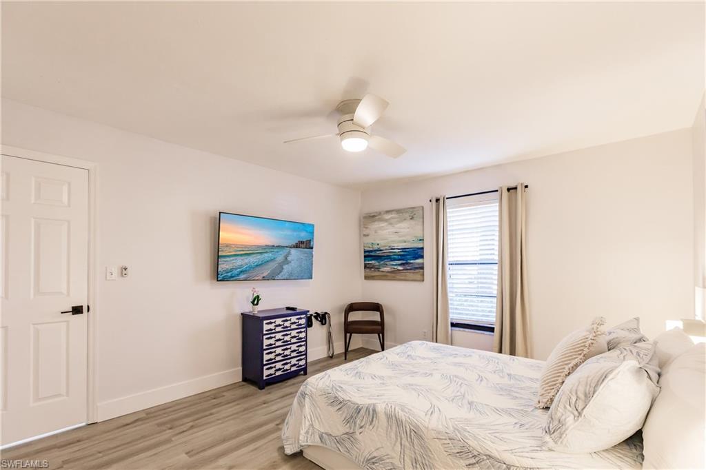 600 Neapolitan Way, Unit 152 Naples, FL 34103 - Photo 15 of 41 a bedroom with a bed and a flat screen tv