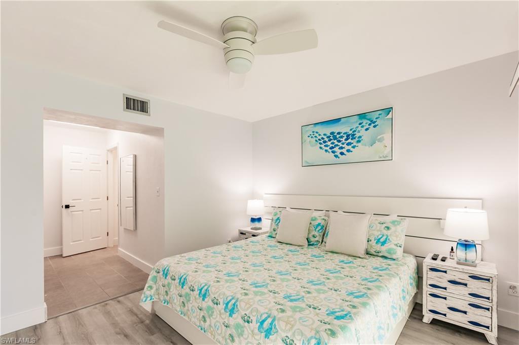 600 Neapolitan Way, Unit 152 Naples, FL 34103 - Photo 8 of 41 a bedroom with a bed and a walk in closet