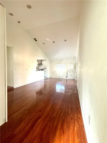 a view of a room with wooden floor