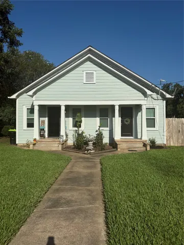 a front view of a house with yard patio and green space