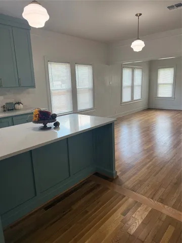 a room with wooden floor and window