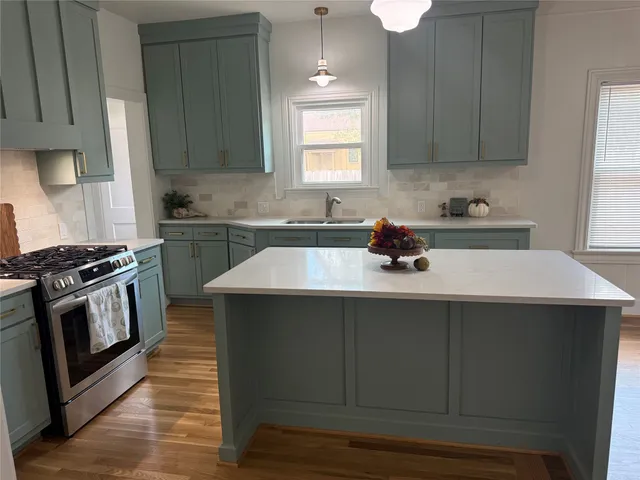 a kitchen with a sink cabinets and stainless steel appliances