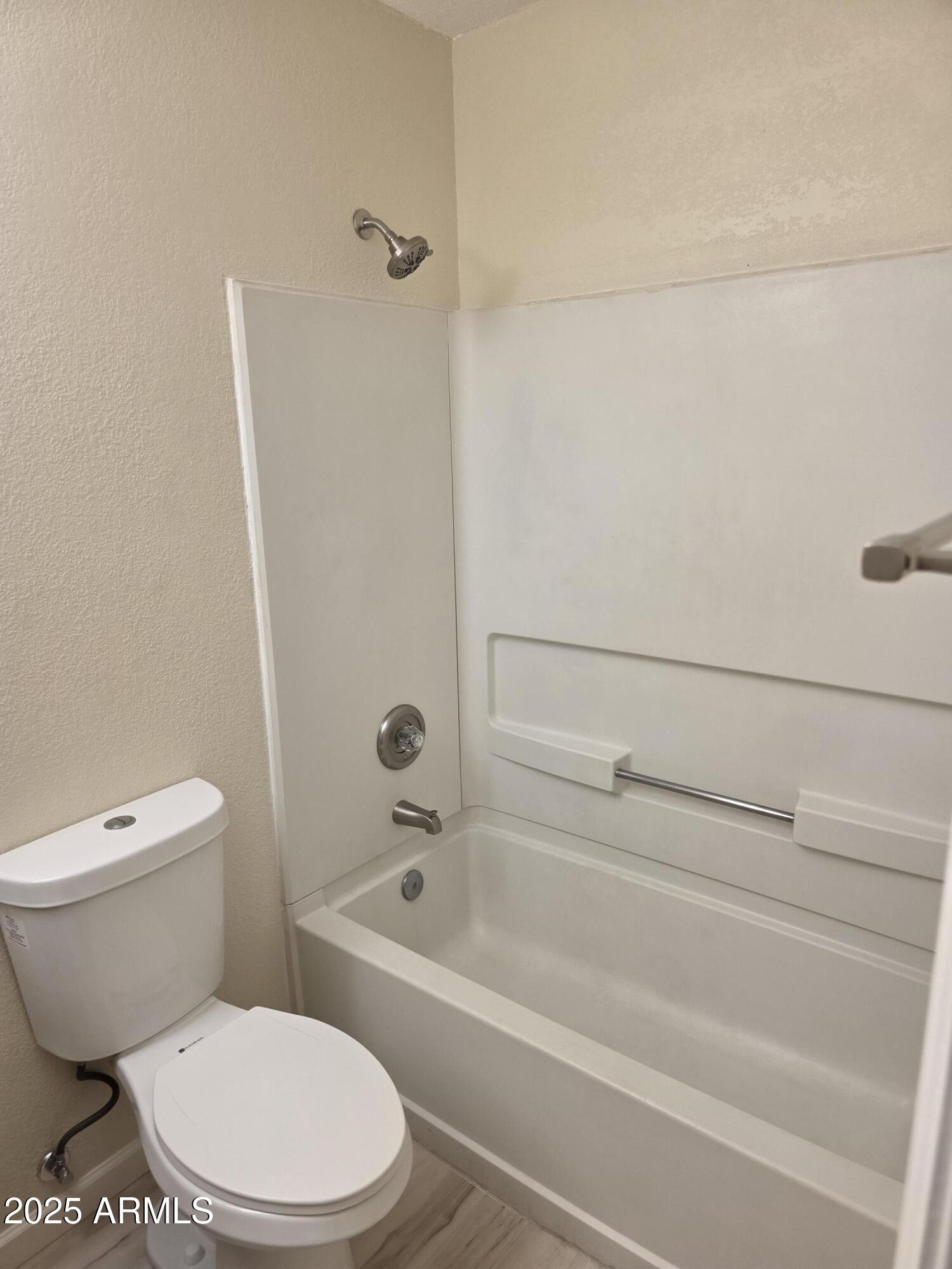 3511 East Baseline Road, Unit 1117 Phoenix, AZ 85042 - Photo 12 of 30 a bathroom with a toilet and a bath tub