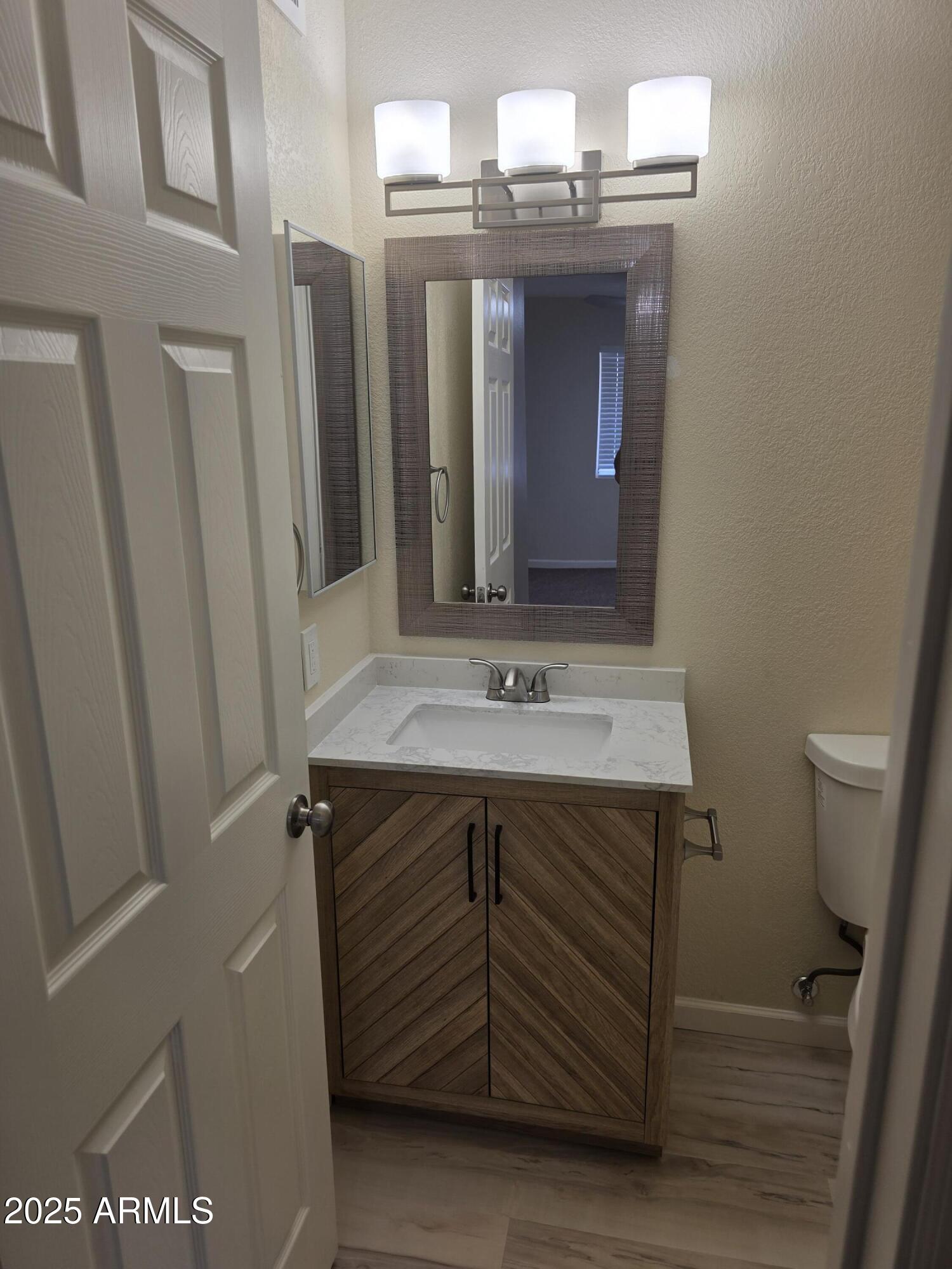 3511 East Baseline Road, Unit 1117 Phoenix, AZ 85042 - Photo 13 of 30 a bathroom with a sink and a mirror