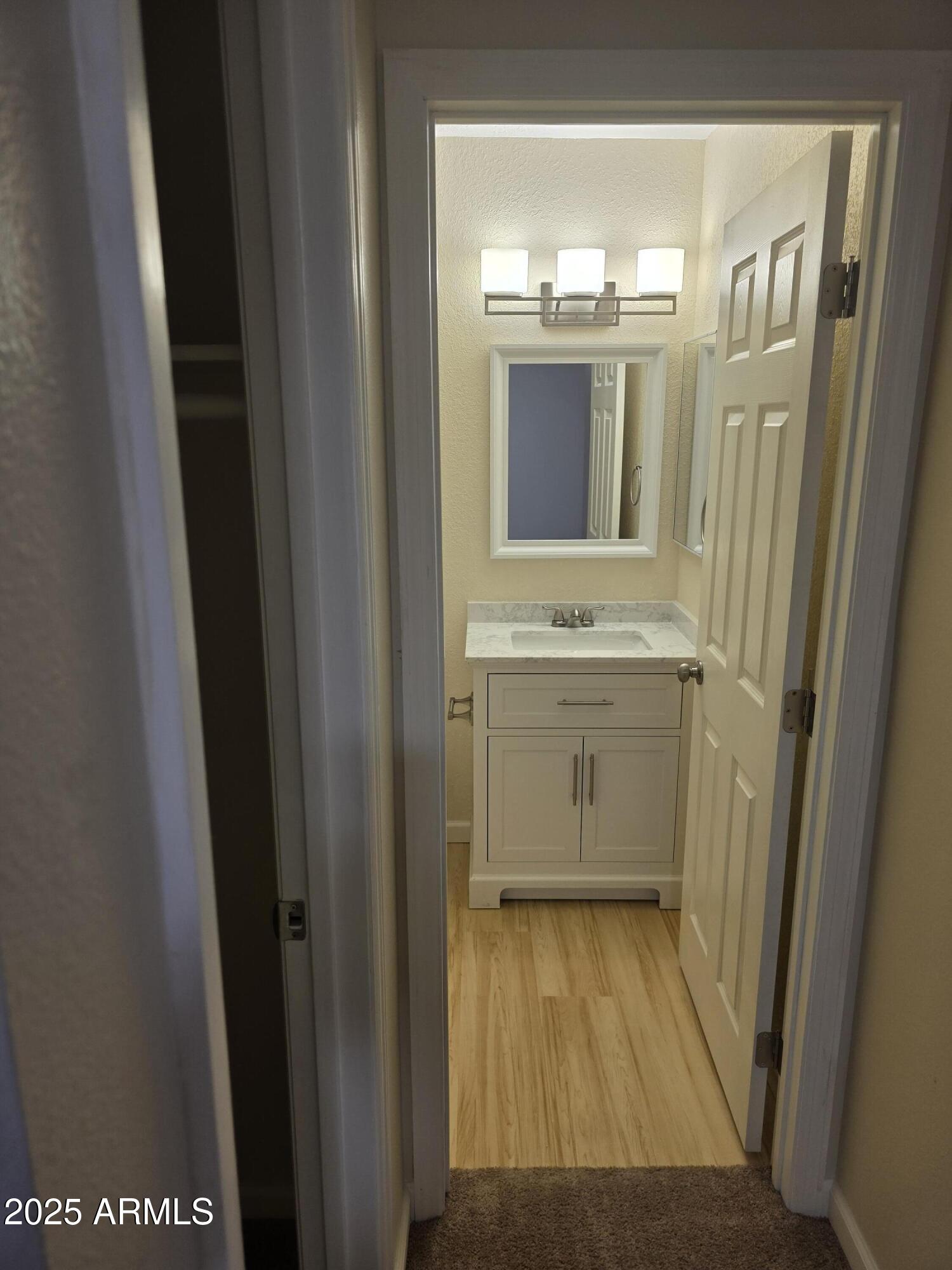 3511 East Baseline Road, Unit 1117 Phoenix, AZ 85042 - Photo 18 of 30 a bathroom with a sink and a mirror