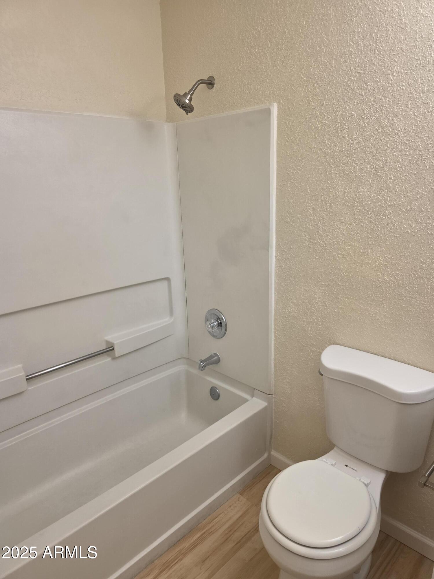 3511 East Baseline Road, Unit 1117 Phoenix, AZ 85042 - Photo 19 of 30 a white toilet and tub sitting next to a bathroom sink