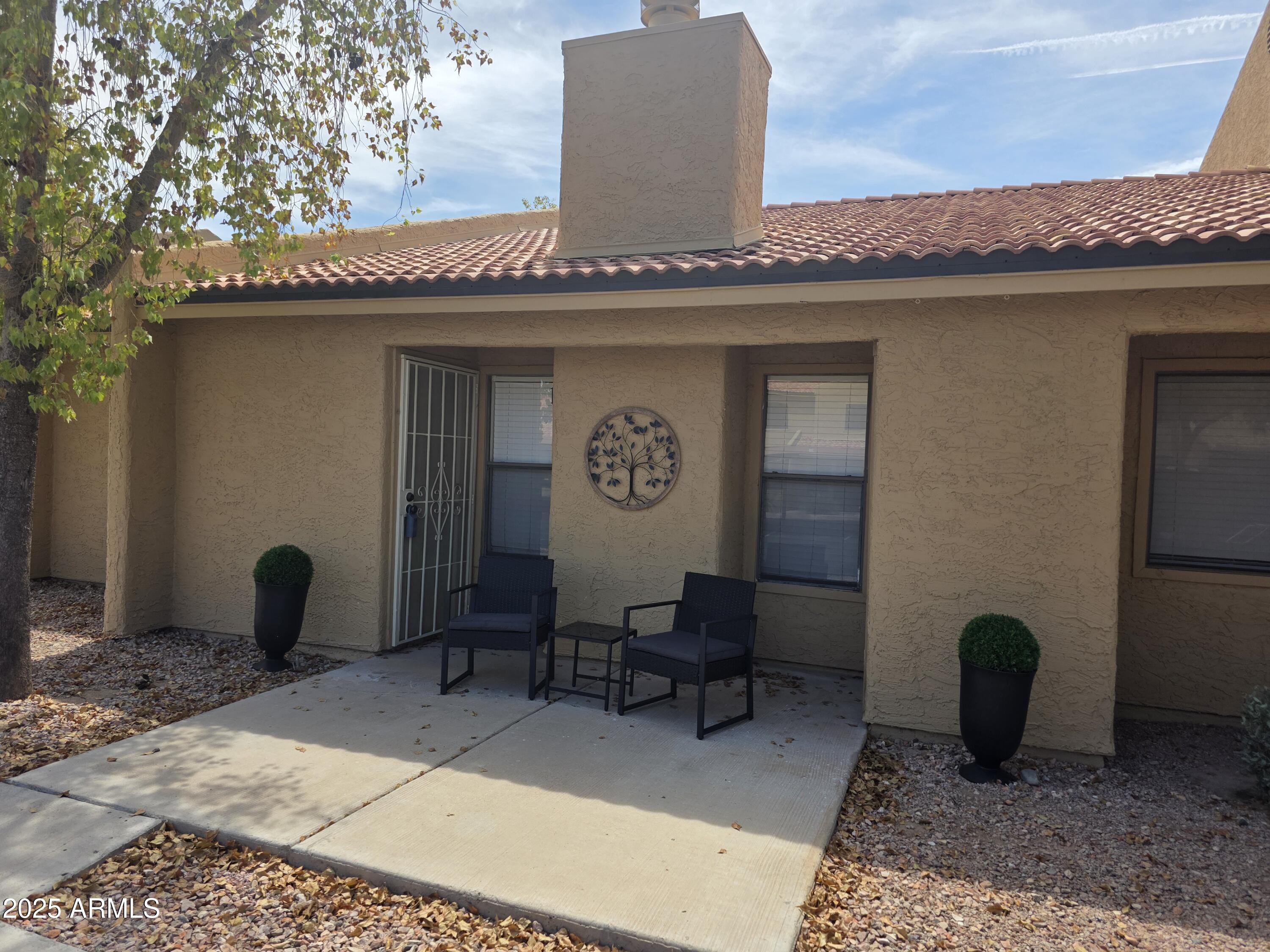 3511 East Baseline Road, Unit 1117 Phoenix, AZ 85042 - Photo 2 of 30 a view of a terrace with sitting area