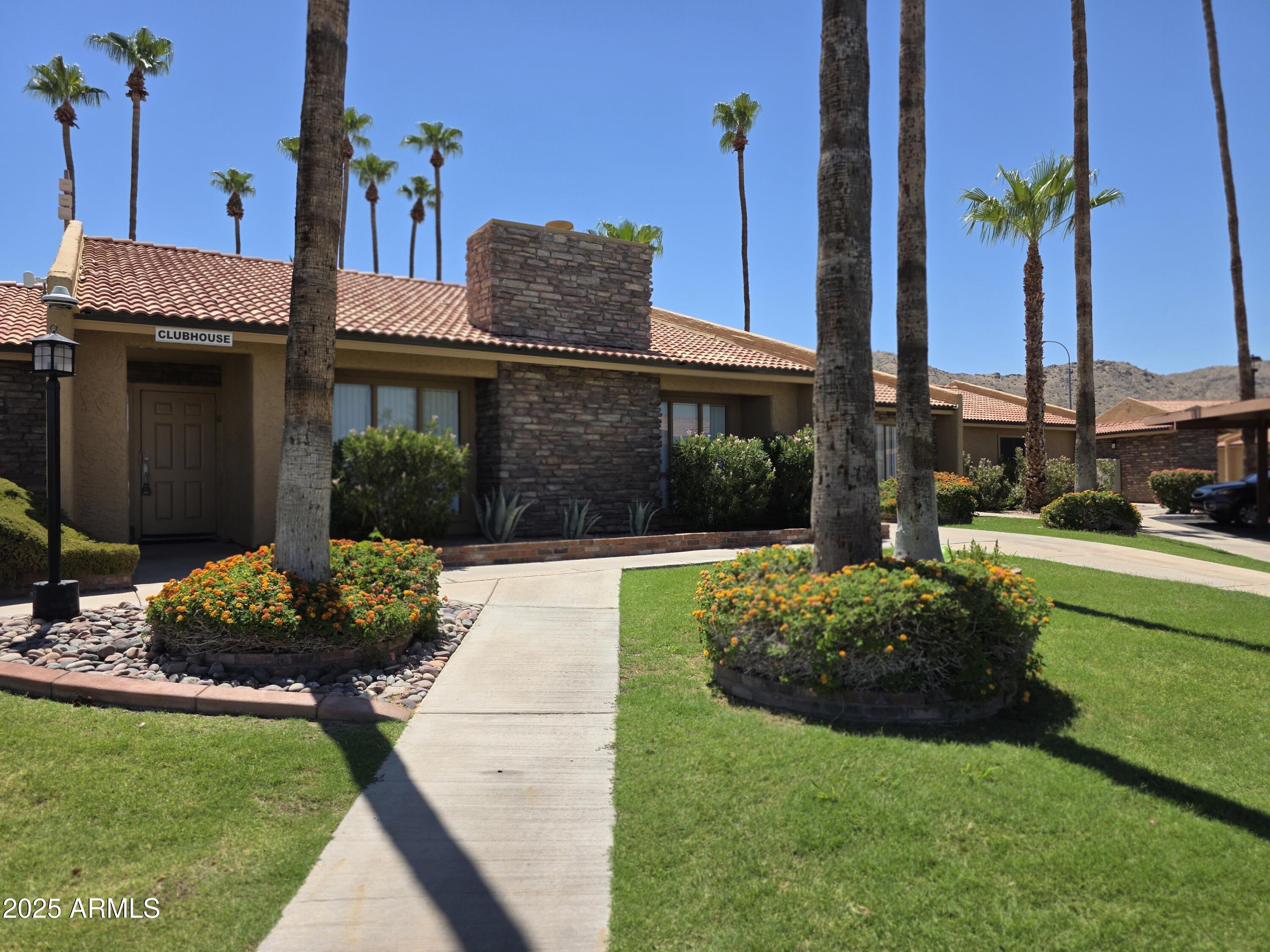 3511 East Baseline Road, Unit 1117 Phoenix, AZ 85042 - Photo 21 of 30 a front view of a house with garden