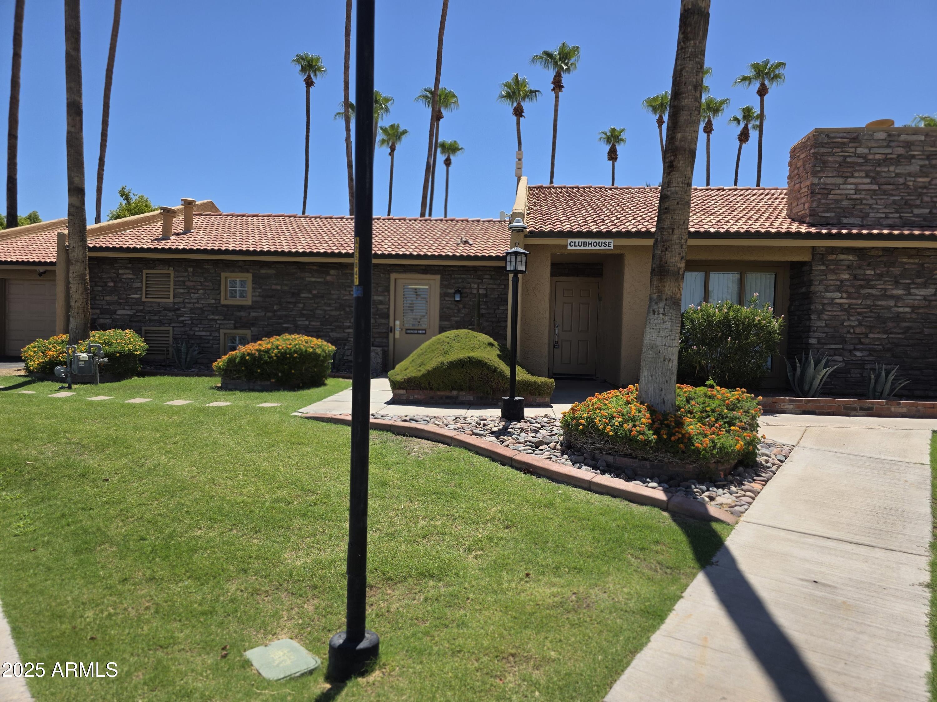 3511 East Baseline Road, Unit 1117 Phoenix, AZ 85042 - Photo 22 of 30 a front view of a house with garden