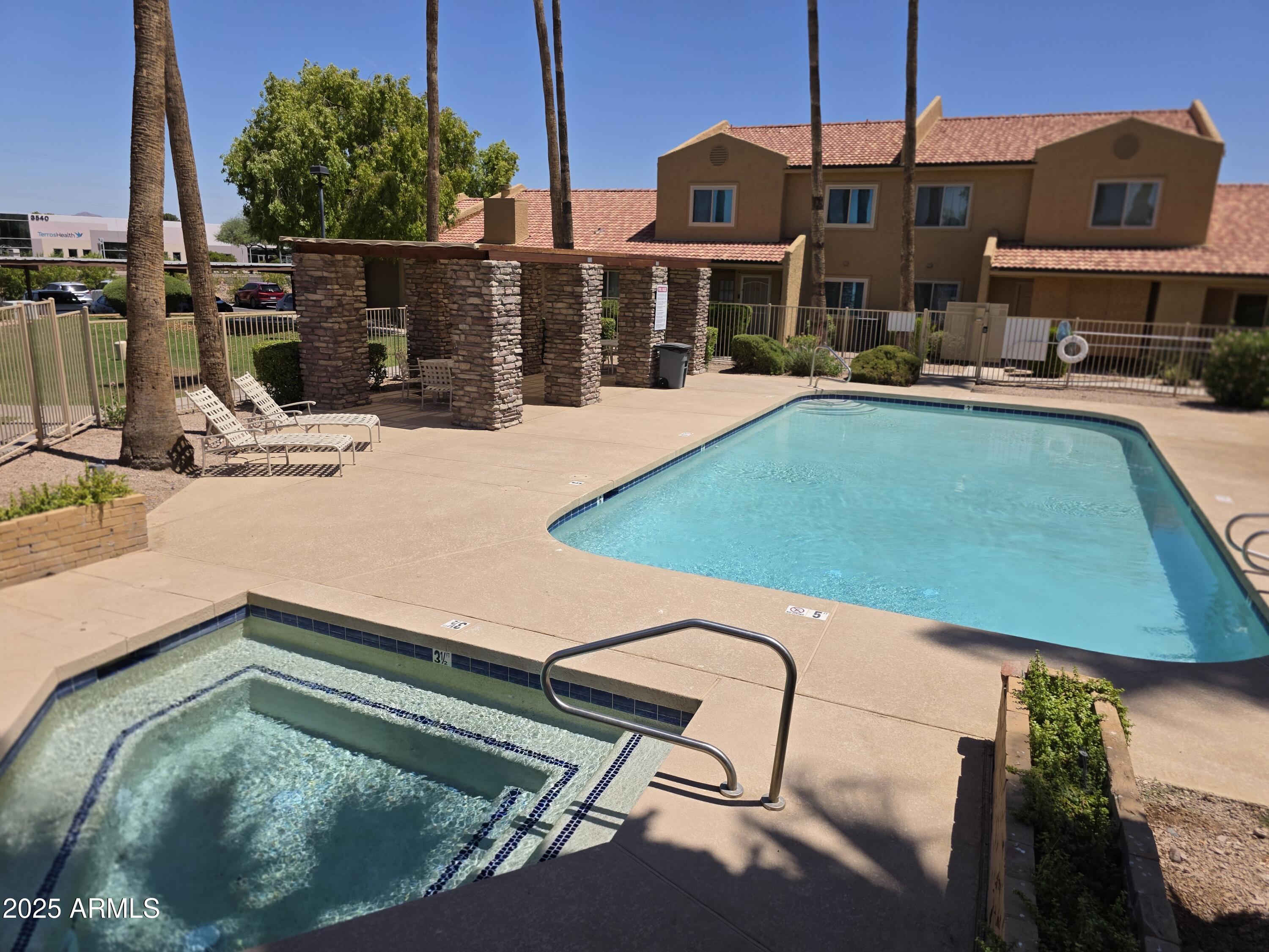 3511 East Baseline Road, Unit 1117 Phoenix, AZ 85042 - Photo 27 of 30 a view of a swimming pool with a patio