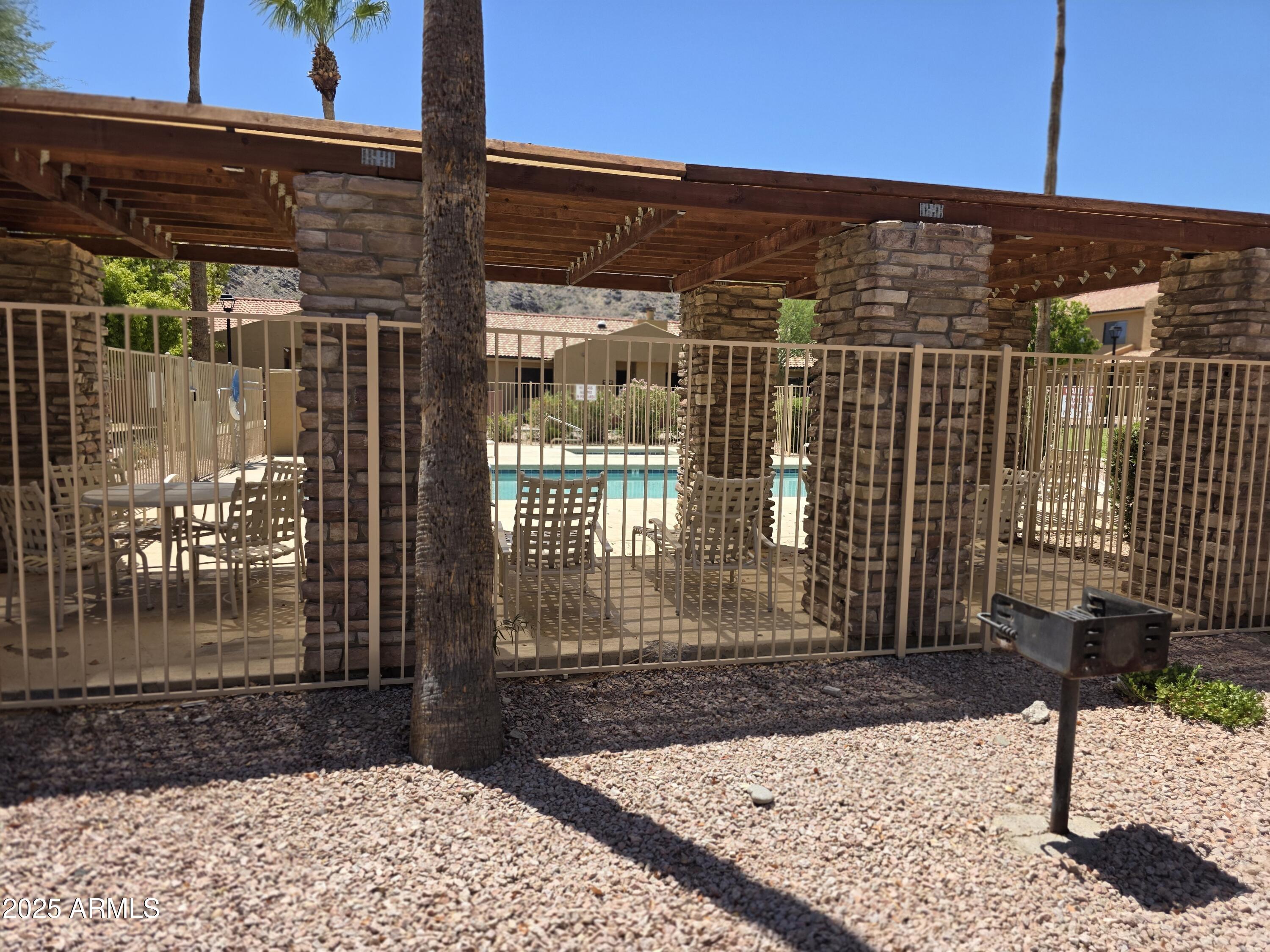 3511 East Baseline Road, Unit 1117 Phoenix, AZ 85042 - Photo 29 of 30 a view of a brick house with a street